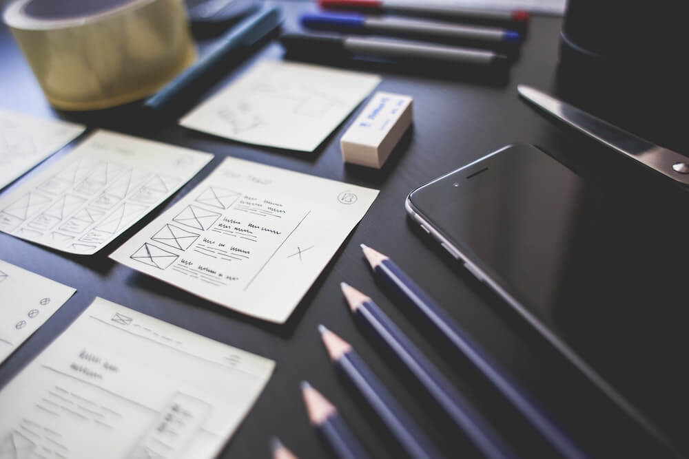 A desk with UX design illustrations laid out
